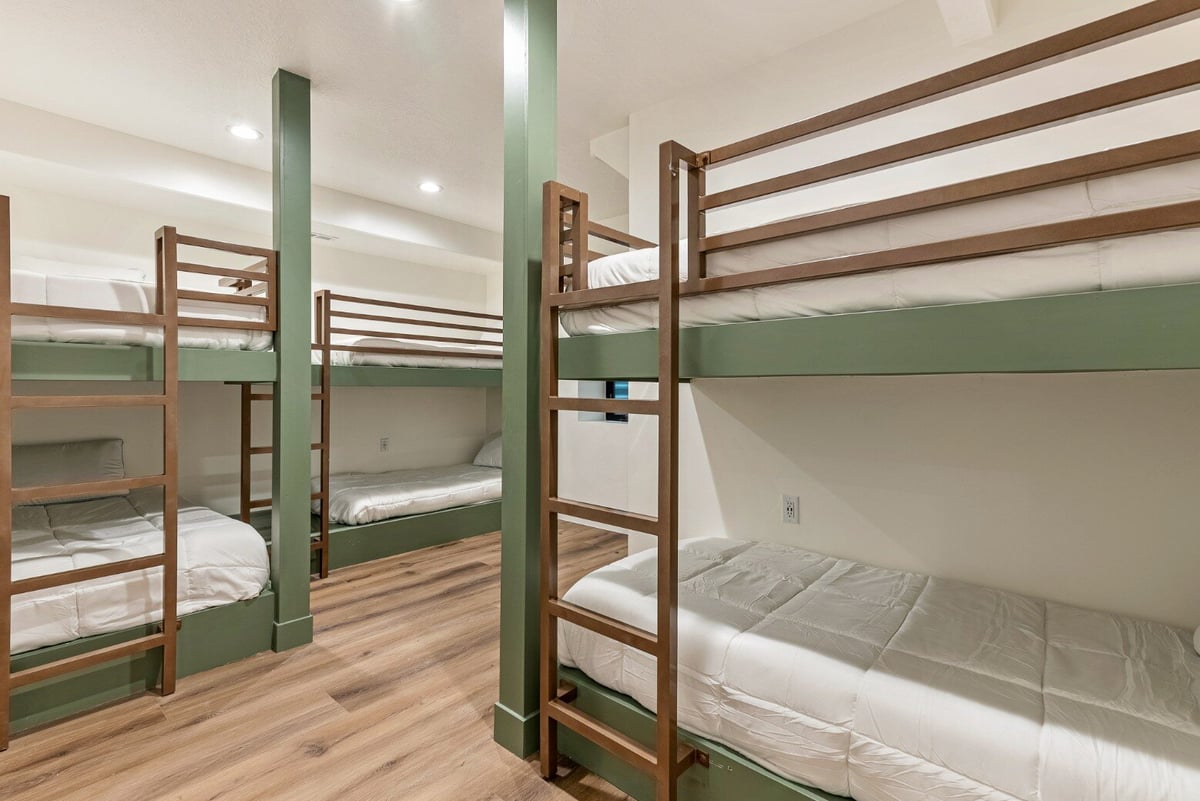 Bedroom with Three Bunk Beds in Bear Lake Custom Home by 10X Builders