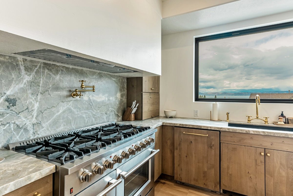 Gas Stove and Partial View of Window Above Kitchen Sink in Bear Lake Custom Home by 10X Builders