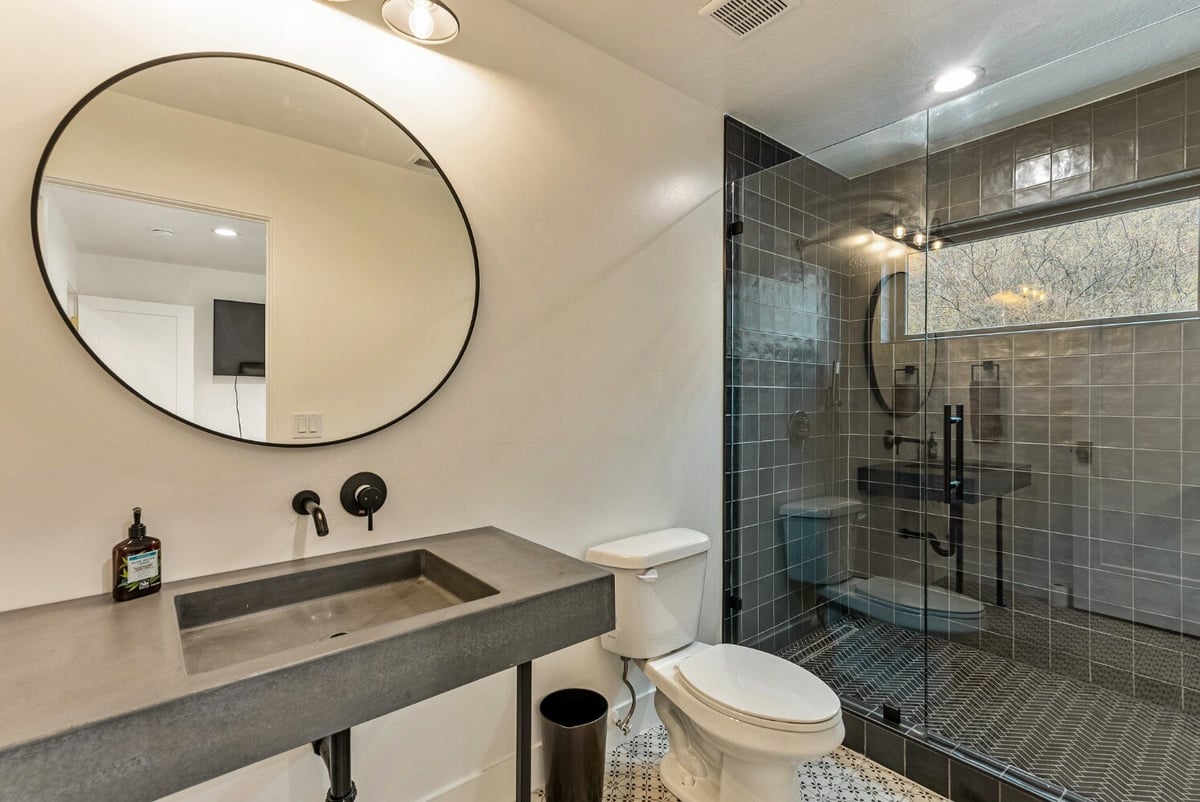 Guest Bathroom with Walk-in Dark Tile Shower with Window in Bear Lake Custom Home by 10X Builders