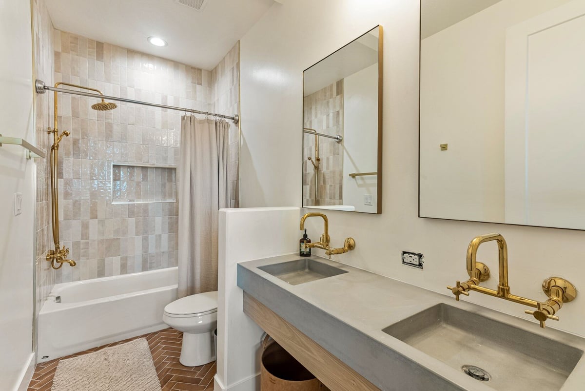 Jack and Jills Sinks with Brass Detailing and Tile Shower in Bear Lake Custom Home by 10X Builders