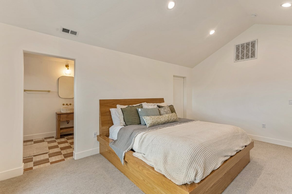 Master Bedroom with Attached Bathroom in Bear Lake Custom Home by 10X Builders