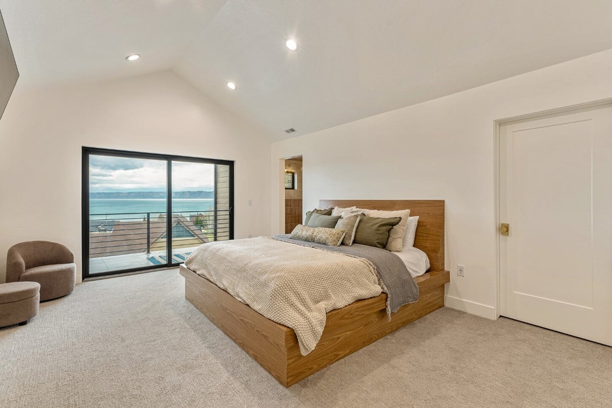 Master Bedroom with Balcony and Attached Bathroom in Bear Lake Custom Home by 10X Builders