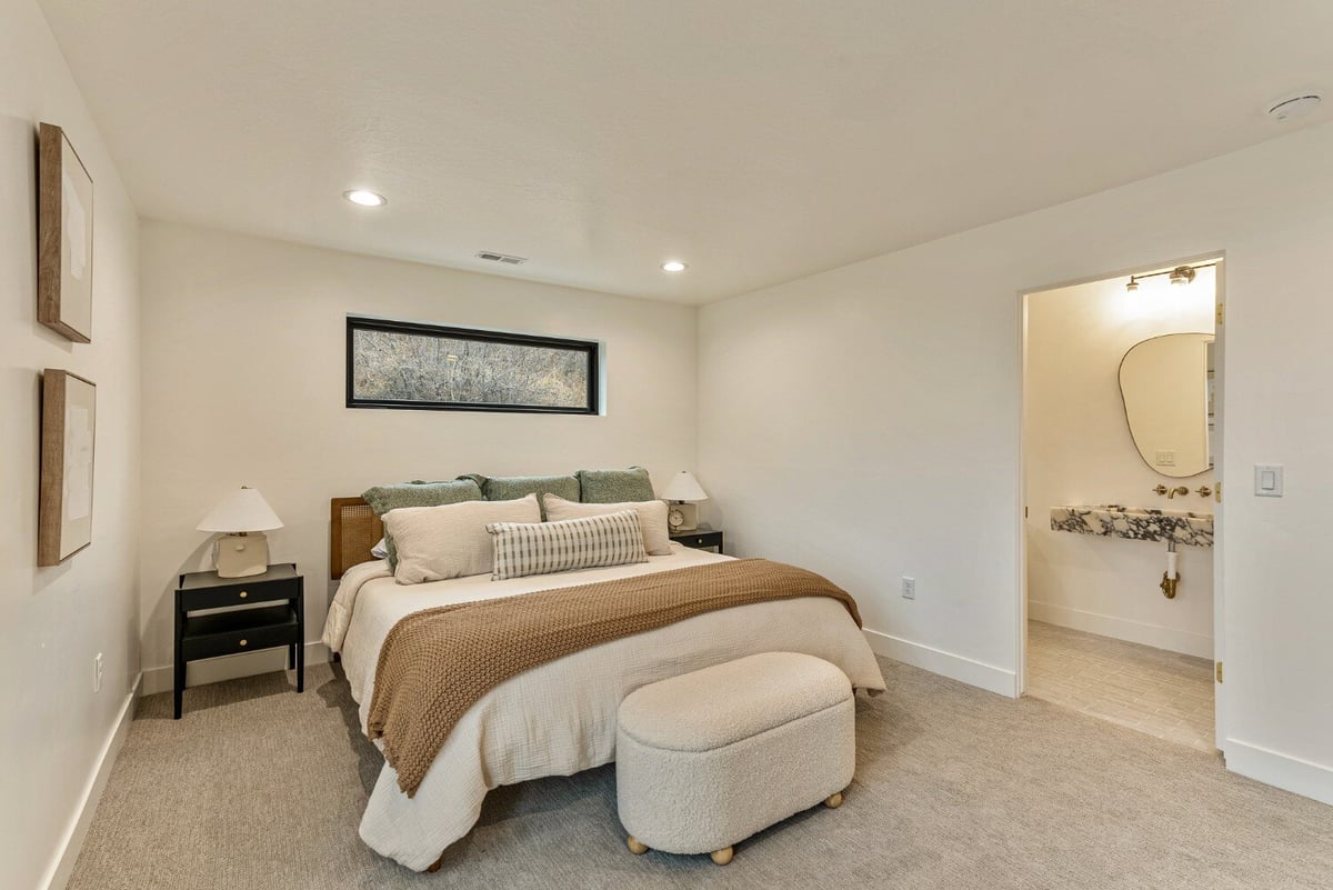 Neutral Guest Bedroom with Attached Bathroom in Bear Lake Custom Home by 10X Builders