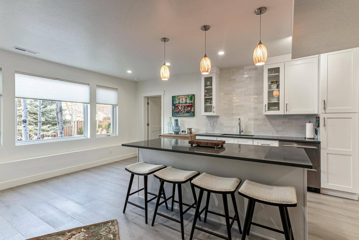 Bar Area with Windows,  Island and Barstools, and Stoarge in Remodeled Utah Home