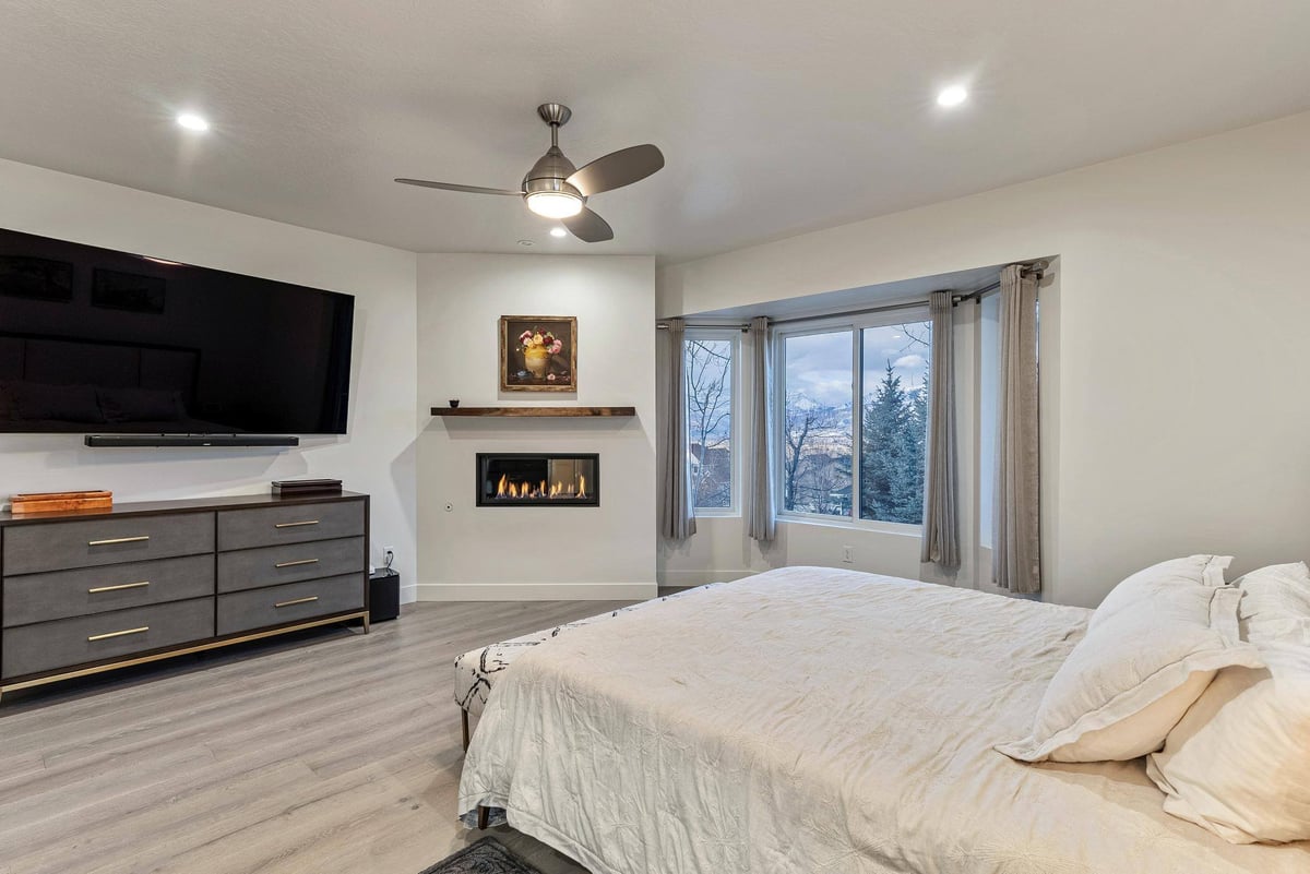 View of Flatscreen TV and Built-in Fireplace in Master Bedroom in Remodeled Utah Home